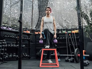 Adult male performing kettlebell exercises in a modern Mexico City gym.